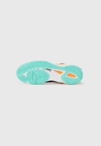 Athletic shoe sole in black, white, and mint green with textured grip patterns and orange accents for traction and support.