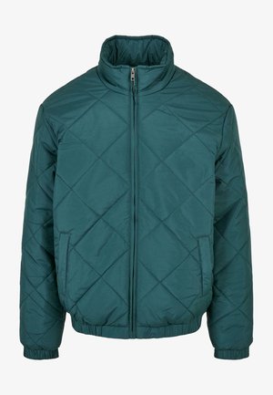 Turquoise quilted jakke med høj krave, fuld lynlås foran og elastiske manchetter og kant. Har sidelommer og diamantmønster syning.