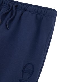 Marineblaue Jogginghosen aus weichem Stoff mit einem elastischen Bund und Kordelzug sowie einem kleinen gestickten Logo an der Seite.