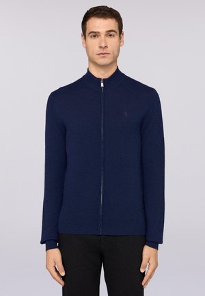 Marineblaue Strickjacke mit Reißverschluss und hohem Kragen, glatter Textur, langen Ärmeln und dezentem Logo auf der linken Brust.