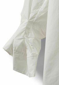 White shirt with a smooth texture, featuring a slightly ruffled sleeve design and a structured collar. Visible stitching along the cuffs.