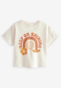 Šviesiai rožinė trumpa rankovė marškinėliai su spalvinga grafika, kurioje yra saulė, vaivorykštė, gėlė ir tekstas "TĘSK SPINDESĮ". Minkštas medvilnės audinys.