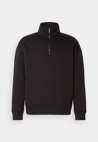 Sweatshirt negru cu fermoar la jumătate, fabricat dintr-un material moale, având un guler înalt și manșete ribbate. Logo-ul subtil Calvin Klein pe piept.