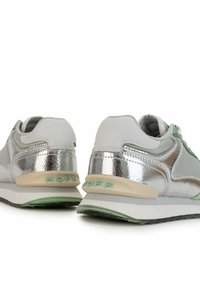 Silver and grey sneakers with a shiny metallic finish, textured accents, soft green detailing, and a beige midsole featuring "HOFF" branding.