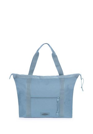 Light blue Eastpak tote bag with dual handles, front zippered pocket, and top zipper closure with pull cords on a white background.