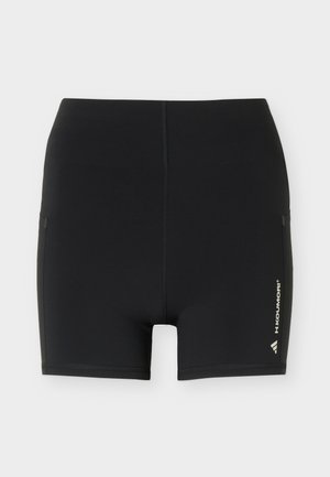 Black fitted athletic shorts with central seam and "H.KOUMORI" branding on lower right leg.