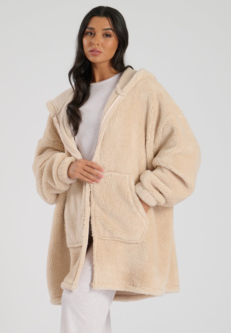 Crème nepbont oversized hoodie met voorzakken en geribbelde manchetten. Heeft een zachte textuur en een relaxte pasvorm, geschikt voor lagen.