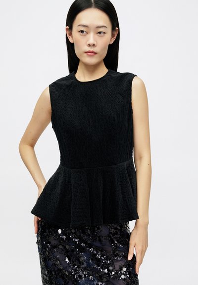 Top peplum negru din țesătură texturată, cu guler rotund și design fără mâneci, asortat cu o fustă cu paiete în nuanțe întunecate.