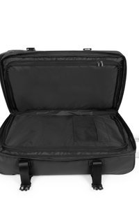 Schwarze Reisetasche mit einem geräumigen, geöffneten Innenraum, ausgestattet mit einem Netzfach und zwei Reißverschlussfächern zur Organisation. Glatte Oberfläche.