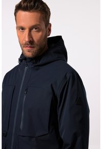 Navy blue hooded jacket with a zip front, two large patch pockets, and a small embossed logo on the shoulder; smooth, weather-resistant fabric.