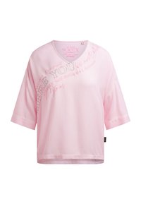 Light pink short-sleeve V-neck shirt with loose fit and curved text design on upper left side reading "BE YOU" and other motivational phrases.