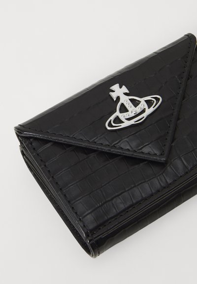 Black patent crocodile-embossed wallet with a triangular flap, featuring a silver logo accent and stitching detail along the edges.