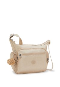 Borsa a tracolla beige con multiple tasche con zip, tracolla regolabile e un piccolo portachiavi a forma di scimmietta di peluche attaccato sul lato.