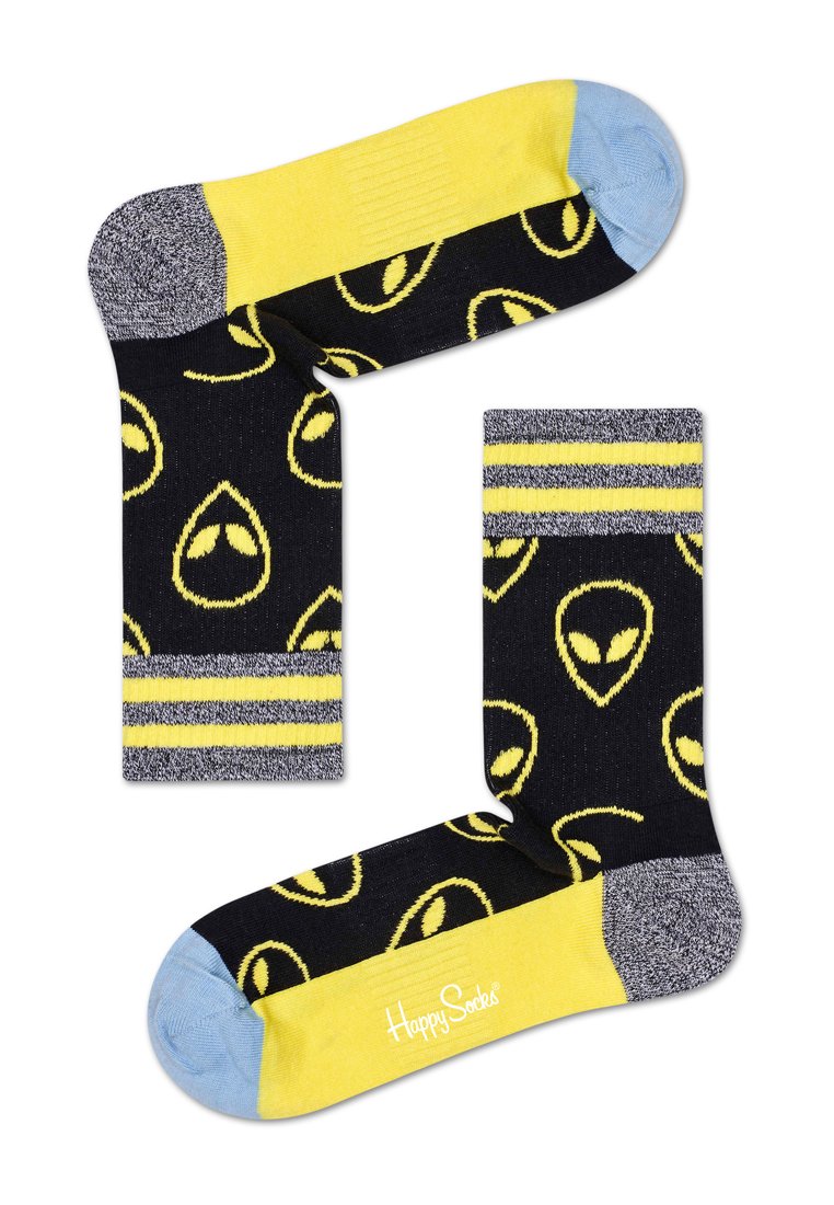 Czarne skarpetki z żółtymi wzorami głów obcych, z żółtymi i szarymi akcentami przy mankietach i palcach, wykonane z miękkiego materiału dzianinowego.