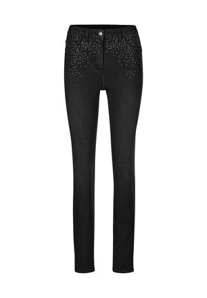 Schwarze Skinny Jeans mit verstreuten silbernen Nieten um die vorderen Taschen, Knopfverschluss und Five-Pocket-Design.