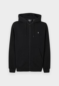 Sweat à capuche noir zippé avec poches avant, capuche à cordon de serrage, et petit logo blanc sur la poitrine gauche sur un fond clair uni.