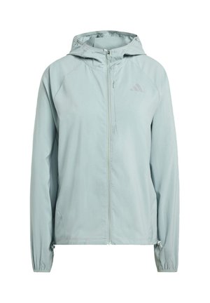 Ljusblå huvjacka med dragkedja framtill, raglanärmar och elastiska manschetter. Har en liten logotyp på övre högra sidan.