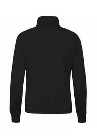 Giacca nera con zip e colletto alto, caratterizzata da strisce a contrasto lungo le maniche e una finitura texturizzata. Polsini e orlo a coste.