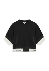 Schwarzes cropped Sweatshirt mit elastischem weißen Bund, auf dem "LA CRÈME" steht. Enthält Satinpanel-Details und zwei Seitentaschen.
