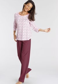 Long-sleeve pink and white striped top paired with maroon wide-leg pants. Soft fabric, relaxed fit, and three-quarter sleeves.