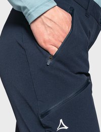 Marineblaue technische Hose mit einem seitlichen Reißverschlussfach und auffälligem Logodesign. Die glatte Textur und das taillierte Design verbessern die Funktionalität.