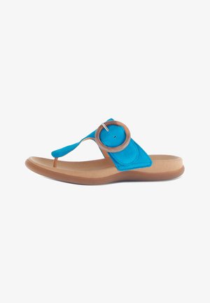 Blue suede flip-flop with a circular brown accent at the toe post, lightweight tan sole, and a smooth texture overall.