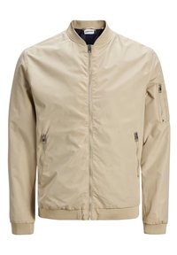 Beige bomberjacka i mjukt tyg, med dragkedja framtill, två sidofickor och en ficka med dragkedja på ärmen. Ribbad manschett och nederkant.