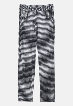 Pantaloni con motivo a scacchi, caratterizzati da una combinazione di nero, bianco e grigio. Progettati con una silhouette aderente e tasche anteriori.