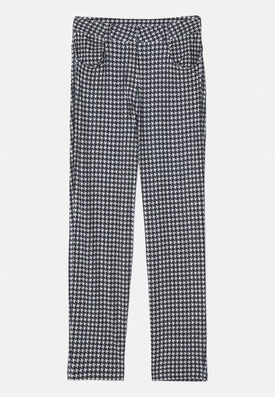 Houndstooth mustikad, valged ja hallid triibud, millel on ühtne lõige ja esi-taskud.