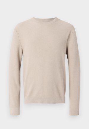 Maglione beige a maniche lunghe con scollo rotondo, polsini e orlo a costine, caratterizzato da un motivo a maglia strutturata.