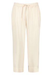 Pantalons de couleur crème avec une taille élastique, fermeture à cordon de serrage, jambes fuselées et texture de tissu lisse. Ne comporte ni poches ni ornements.