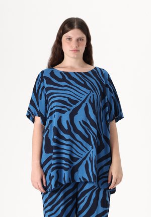 Blue and navy zebra-patterned top, loose fit, wide neckline, and short sleeves. Fabric appears soft with a smooth texture.