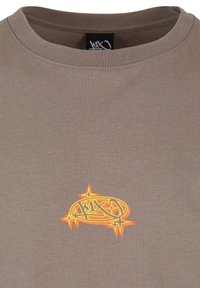 Brun bomull t-skjorte med rund hals, som har en livlig oransje grafisk logo på forsiden, med skarpe detaljer og aksenter.