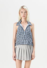 Blue and black plaid halter top with a deep V-neck, front buttons, and a gathered waist design, paired with a light gray pleated skirt.