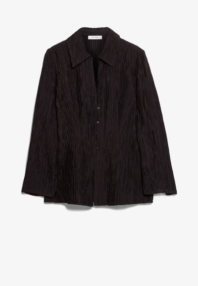 Black long-sleeve shirt with a plissé texture, notched collar, and button front. Features a relaxed fit and subtle sheen.