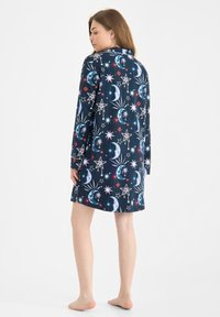 Navy nightdress with long sleeves, featuring a celestial pattern of stars and moons in white, red, and blue, made of soft fabric.