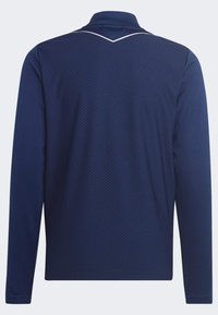 Langärmliges navy Polohemd mit einem strukturierten Rautenmuster und einem weißen Akzent am Kragen. Weicher, atmungsaktiver Stoff.