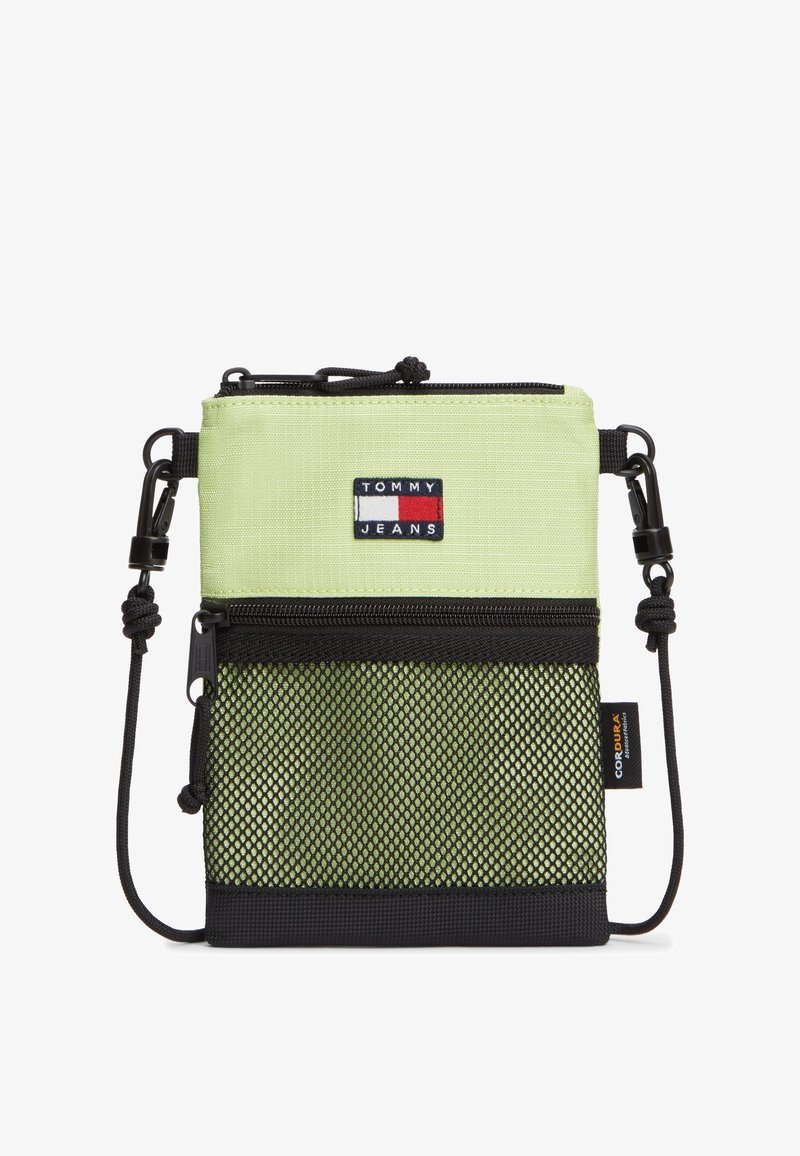 Μικρή τσάντα χιαστί σε ανοιχτό πράσινο και μαύρο χρώμα με μπροστινή τσέπη με φερμουάρ από δίχτυ, ρυθμιζόμενο λουρί κορδόνι και ετικέτα με το λογότυπο Tommy Jeans.
