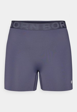 Pantaloni sportivi blu navy con una vita elastica testurizzata etichettata "BORN." Tessuto liscio, design aderente e un piccolo logo sul lato.