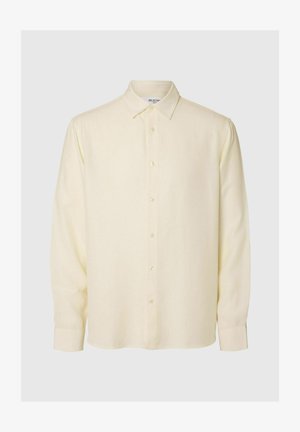 Šviesiai geltona ilga rankovė marškiniai su mygtukų uždarymu, klasikinio tipo apykakle ir minkšta tekstūra. Yra tiesaus kirpimo ir mygtukais užsegamos rankovės.