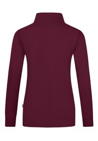 Pullover lungo bordeaux a maniche lunghe con colletto alto, polsini e orlo elasticizzati. Tessuto liscio con un design semplice, senza loghi o motivi visibili.