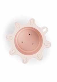 Round silicone bowl in soft pink with a sun-like shape, featuring raised edges and three drainage holes in the center.
