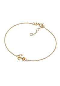Bracelet doré présentant une chaîne délicate avec un charme en forme d'ancre et un fermoir ajustable, mettant en avant une finition métallique lisse et une texture fine.