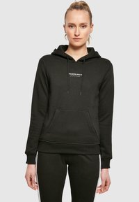 Black hooded sweatshirt with a kangaroo pocket, featuring white text that reads "UNLIMITED SKILLS" on the chest, made of soft fabric.