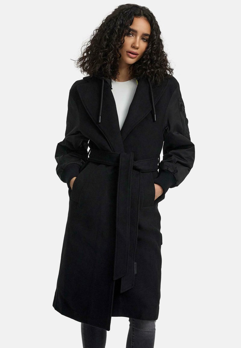 Black long coat with a belted waist, hood, and wide lapels; features two front pockets and ribbed cuffs for added texture.