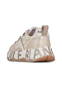 Sneaker with a textured beige upper, cream accents, and a chunky white midsole featuring bold printed text. Light brown rubber outsole.
