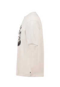 Light beige cotton t-shirt with short sleeves, featuring a black graphic design on the front. Simple round neckline, relaxed fit.