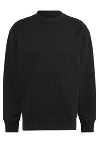 Svart crew neck sweatshirt tillverkad av bomullsblandat tyg. Utrustad med ribbade muddarna och fållen, med en liten ton-i-ton logo på bröstet.