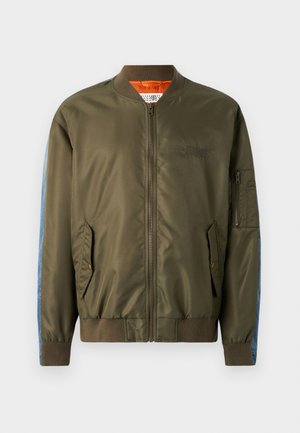Olive green bomber jacket with a zip front, ribbed cuffs, side pockets, and blue denim accents on sleeves; orange lining and embroidered detail.