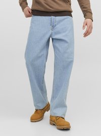  Lichtblauwe rechte spijkerbroek met een vervaagde afwerking, gedragen met tan werkschoenen en een bruine lange mouwshirt, met een comfortabele pasvorm.